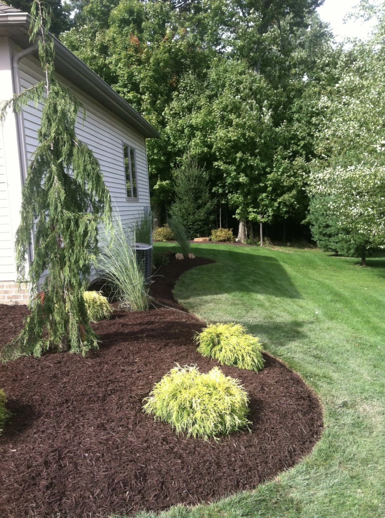 Mulching and planting areas along residential property